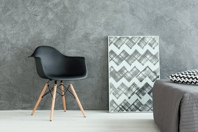 Dark grey wall with light flooring and modern black chair
