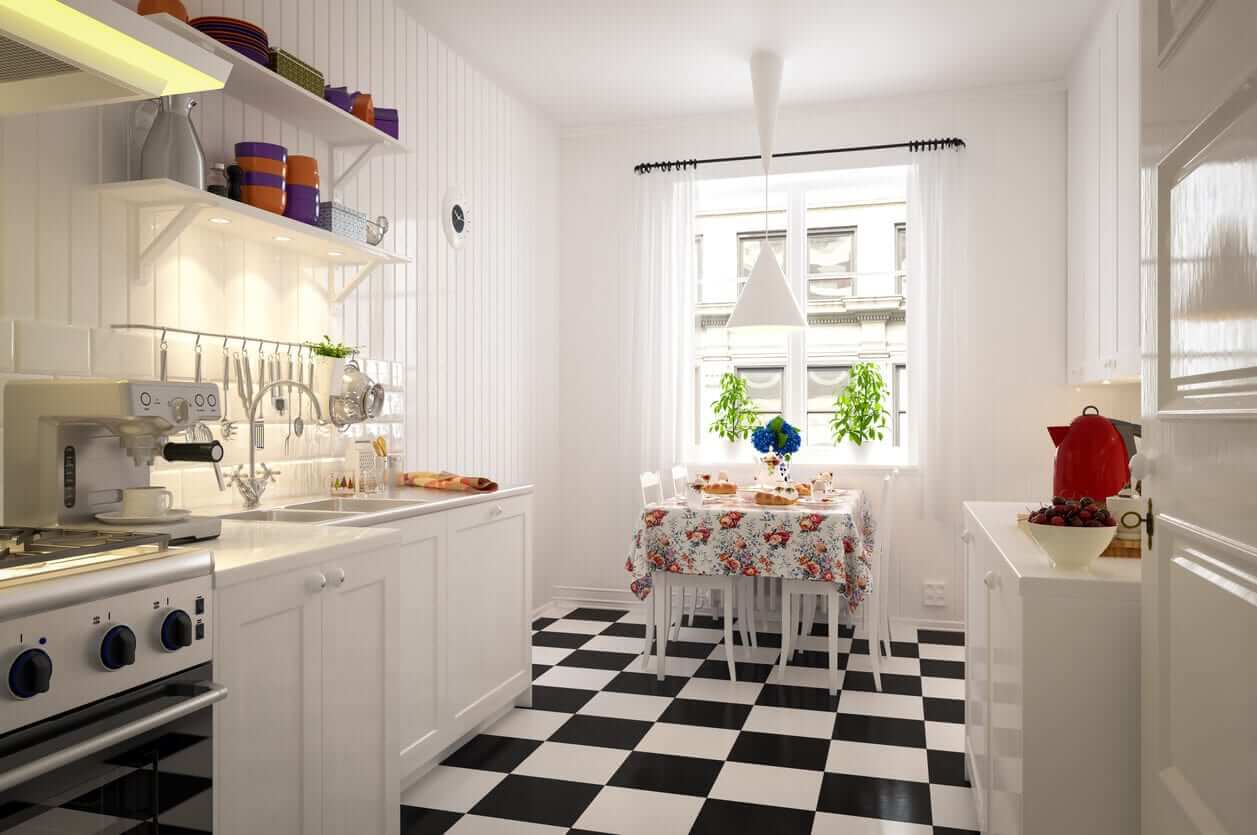 Classic white kitchen with open shelving, a small dining nook and black-and-white checkerboard flooring.