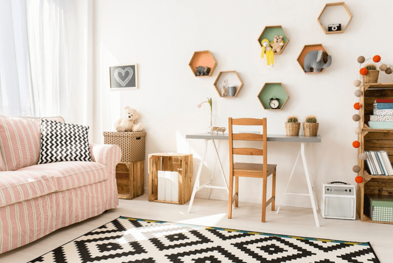 Bright and playful kids’ bedroom with patterned rug, desk and wall shelves