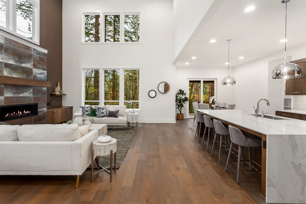 Open-plan living and kitchen area with durable timber-look flooring.
