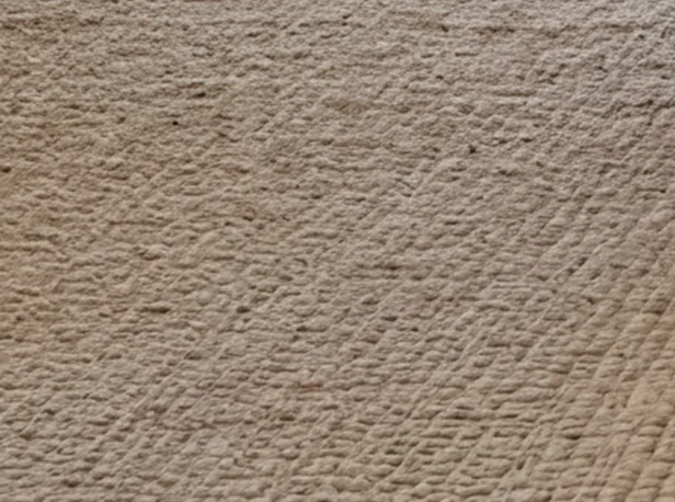Close-up view of a beige textured rug showing natural fiber weave with diagonal pattern and subtle variations in neutral tan and cream tones