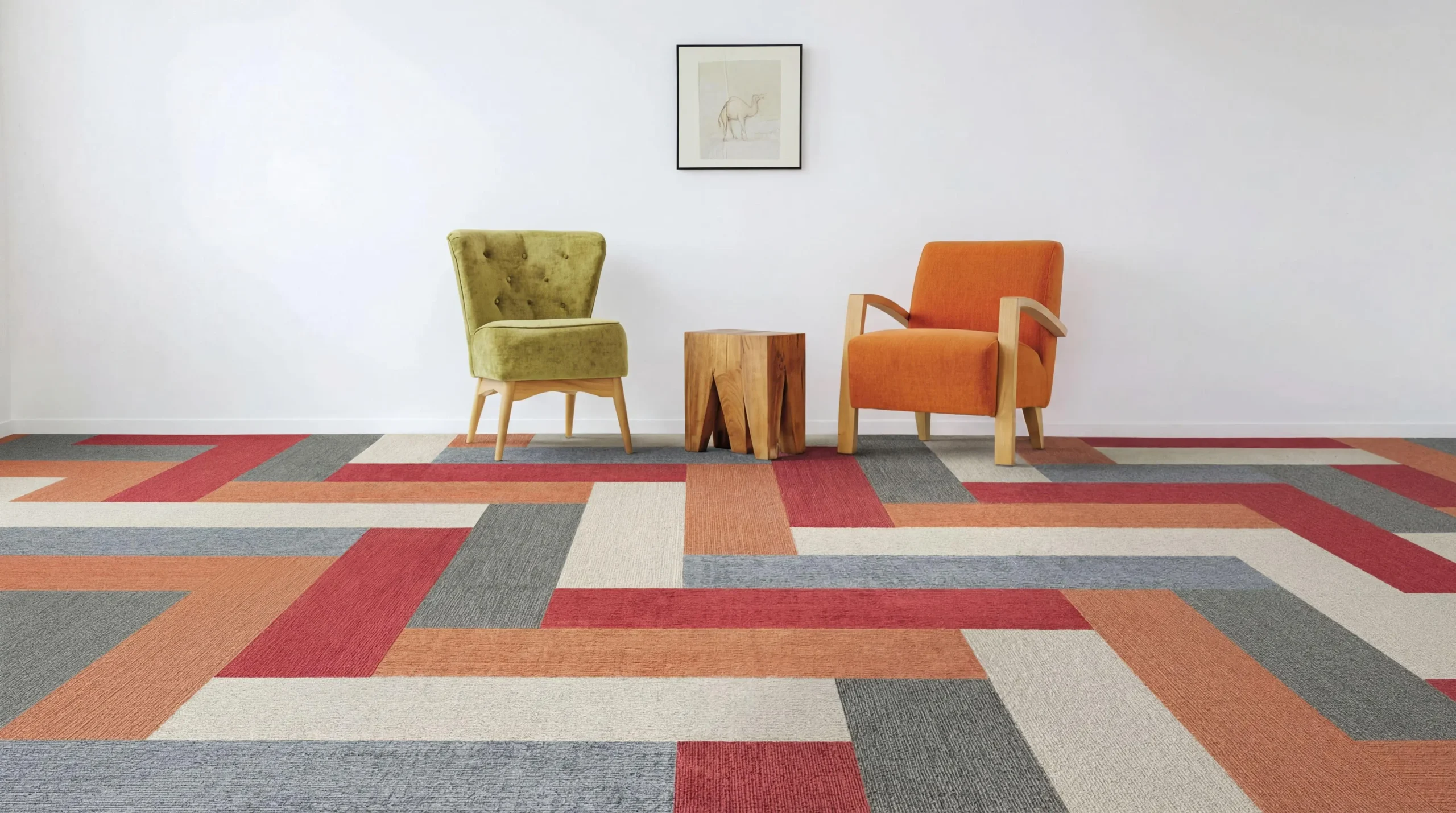 Vibrant geometric carpet design in a modern living room with two chairs and a wooden stool.