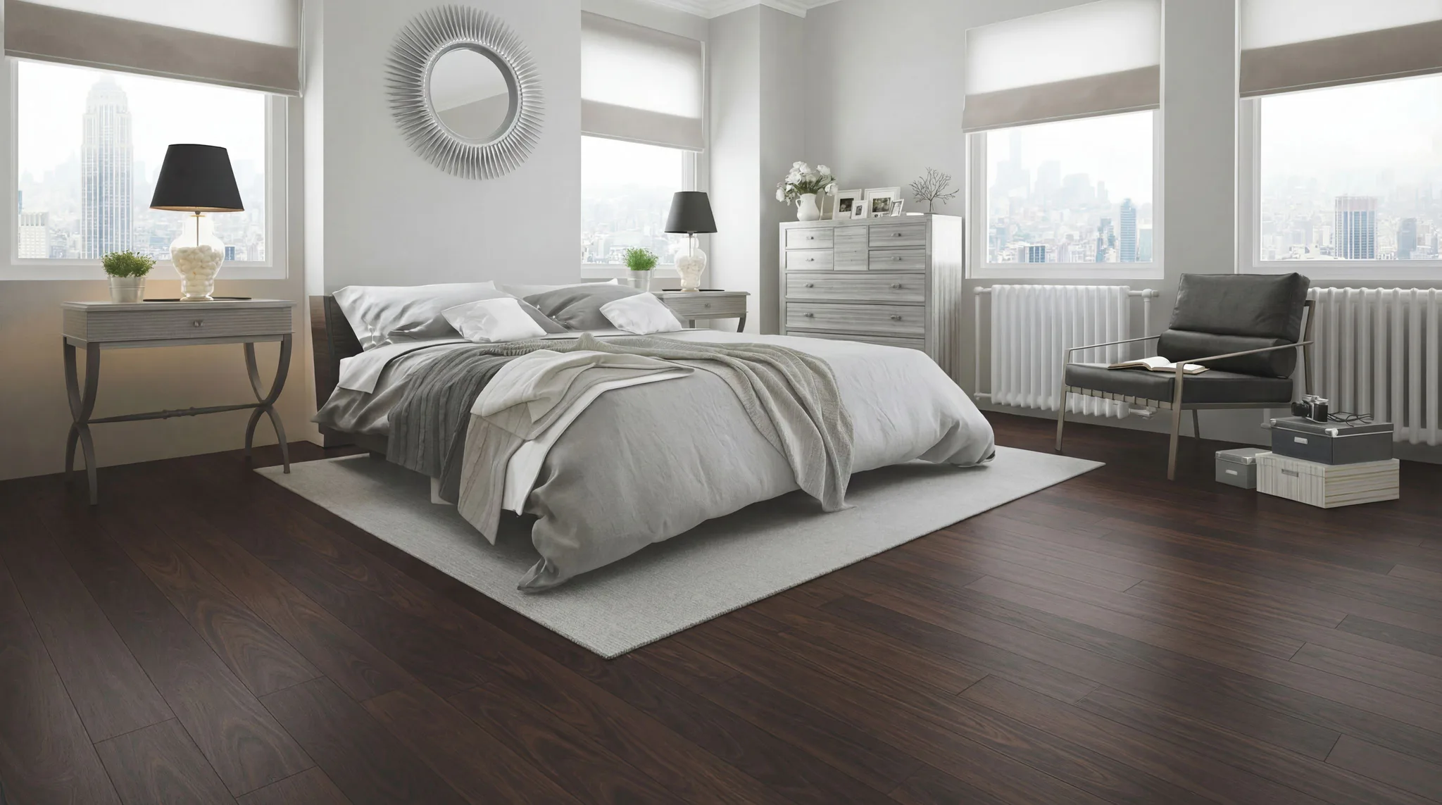 Stylish modern bedroom with dark wood-look laminate flooring, gray bedding, sunburst mirror, chest of drawers, and panoramic city skyline views through large windows