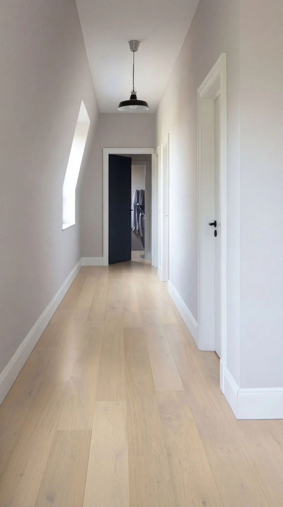 Bright modern hallway featuring light oak engineered timber flooring, white walls, black pendant light, and white doors leading to other rooms