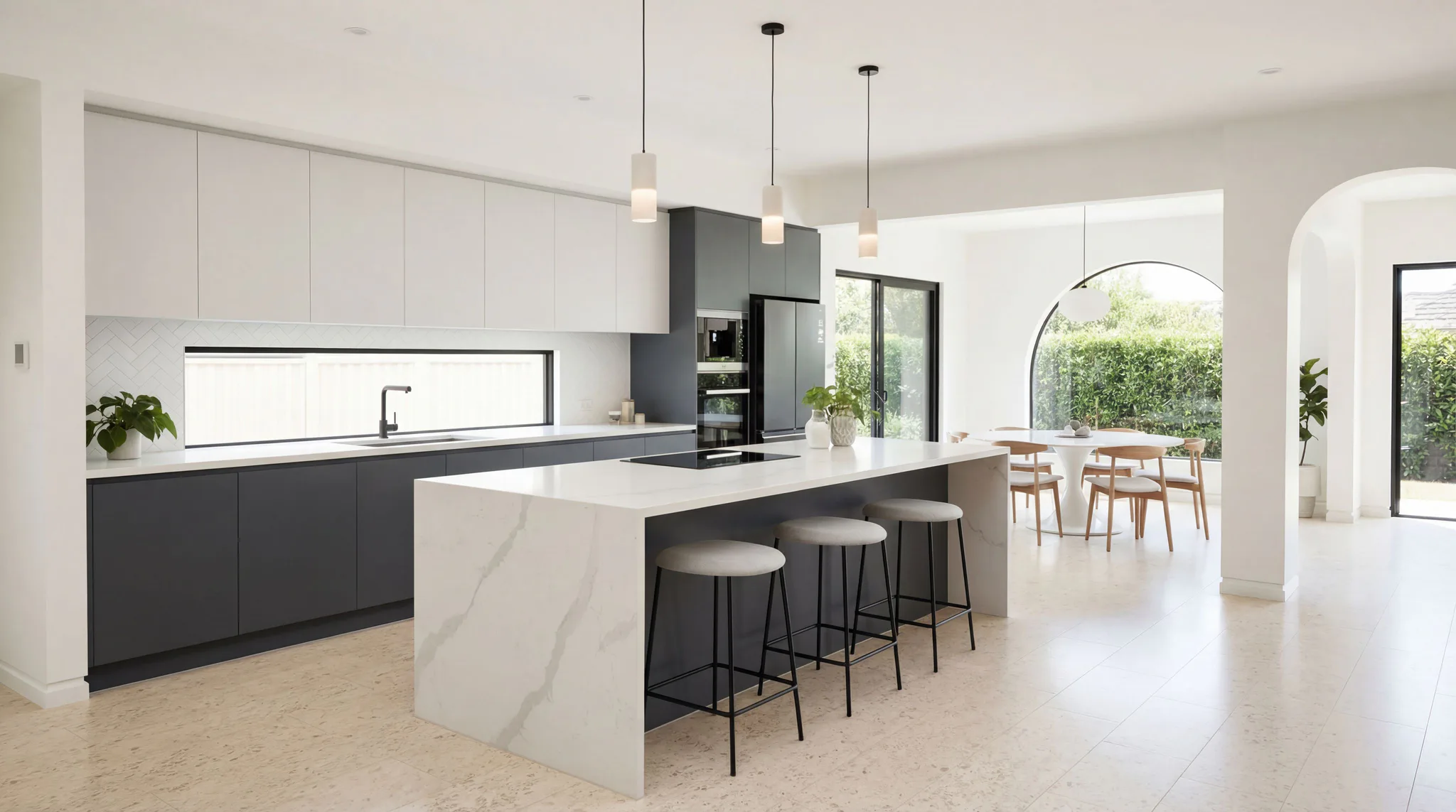 Modern kitchen interior featuring a white marble-effect kitchen island with black bar stools, dark cabinetry, pendant lighting, and an open-plan dining area with wooden chairs visible through an ar...