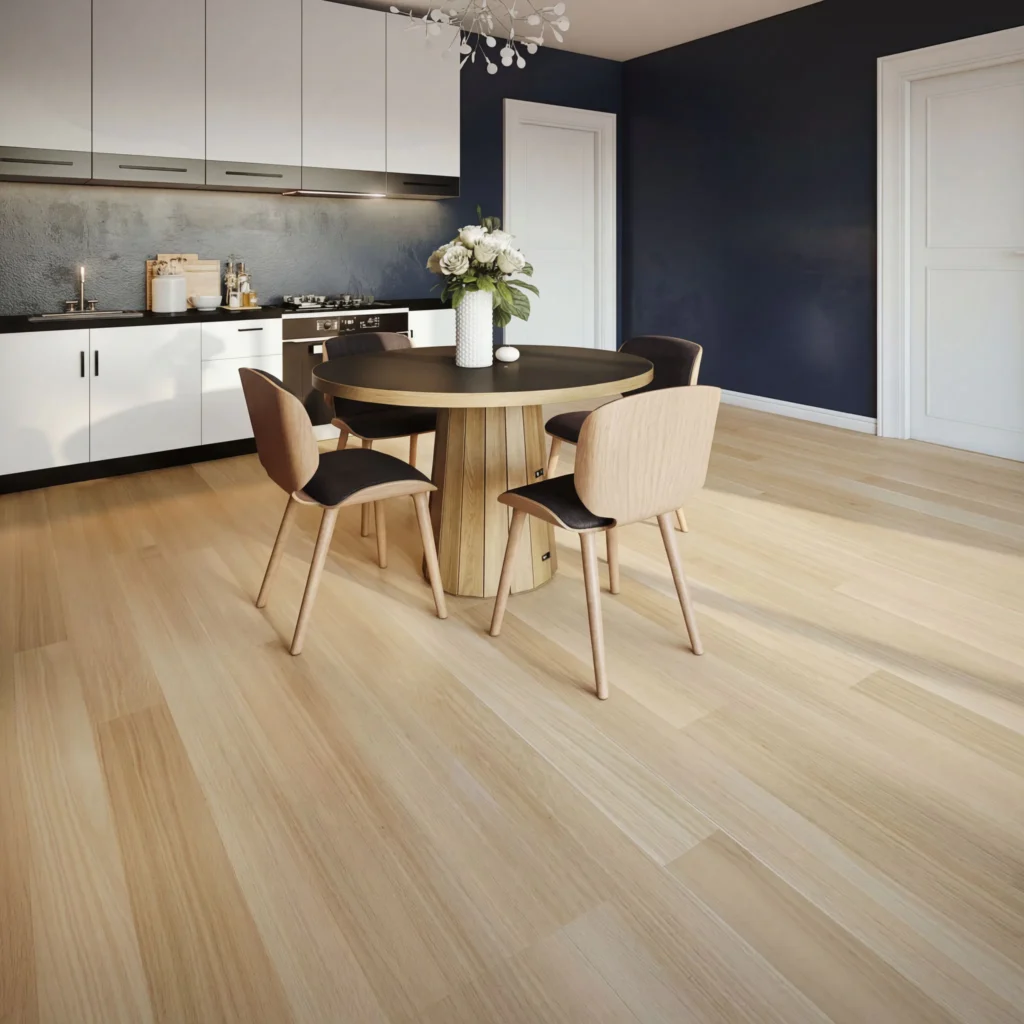 Light timber-look laminate flooring in modern dining room with round wooden table, black chairs, white kitchen cabinets, and navy accent wall