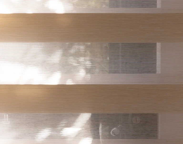 Color swatch showing horizontal bands of soft neutral tones including warm beige, light brown, and cream colors with subtle texture variations and gentle gradients between shades