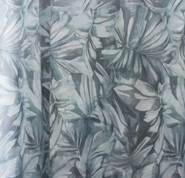 Close-up view of sage green curtain fabric featuring an all-over tropical leaf pattern with palm fronds and botanical motifs in muted tones